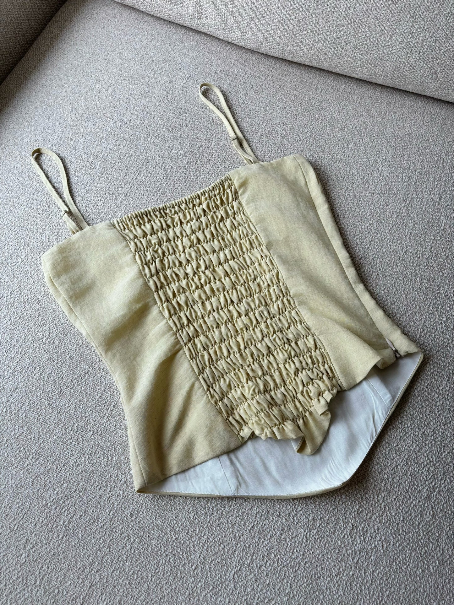 Corset top with stretchable back in light yellow colour. 