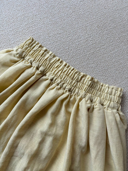 Flowy maxi skirt with stretchable waist band in light yellow colour.